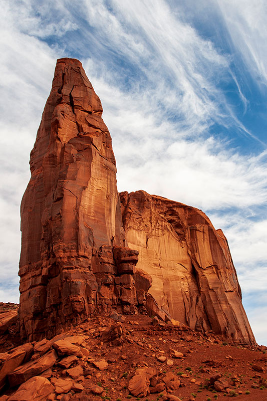 red-orange stone outcropping against a cloudy sky